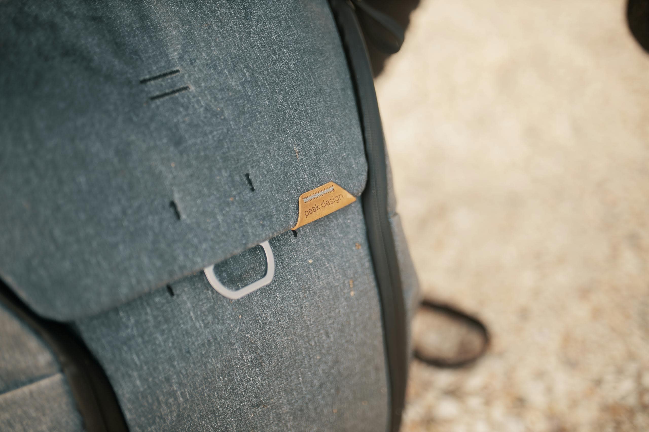 Detailed closeup of a stylish gray backpack highlighting its texture and design features.